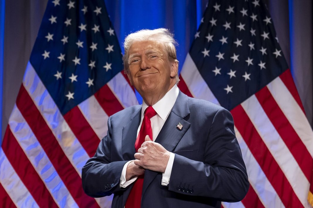 Donald Trump against a backdrop of US flags Donald Trump at a public event