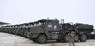 From cars to weapons: British factories are preparing to switch production British military armoured vehicles in a parking area