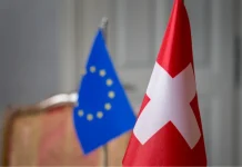 Switzerland is changing its approach to security in the wake of the war in Ukraine The Swiss flag against the backdrop of the new security strategy
