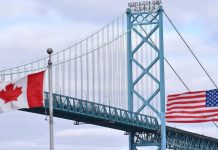 Торгова війна США і Канади загострюється: Оттава ввела мита до 50% Прапори Канади та США на тлі торговельного конфлікту