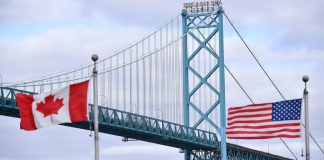The flags of Canada and the US against the backdrop of the trade dispute