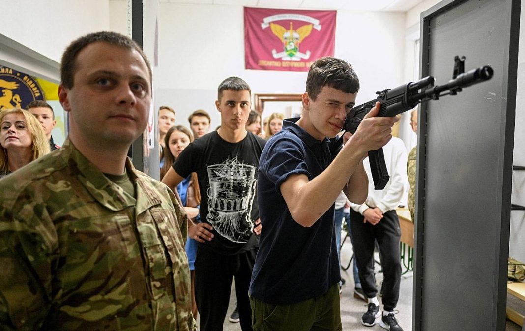 The Foundations of National Resistance Students during a practical session on the basics of national resistance and the handling of weapons