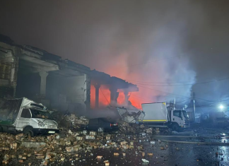Rescue workers are at the scene of a Russian strike on an agricultural enterprise in the Kharkiv region