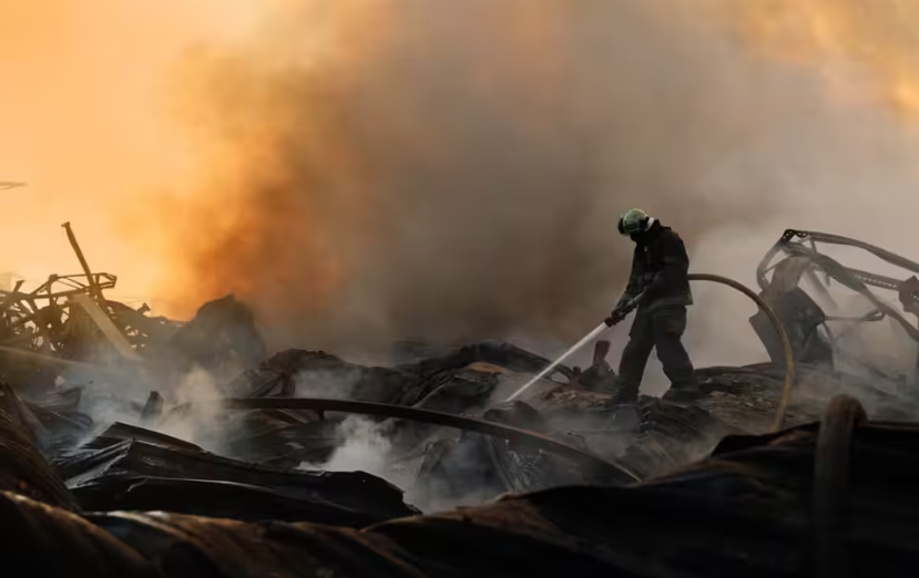Ore A firefighter is putting out a fire following an explosion at a warehouse in Zhytomyr