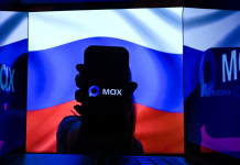 Russian app «Max» turned out to be a ‘backdoor’ in a smartphone: what it can see The Russian app ‘Max’ on a smartphone, with the Russian flag in the background