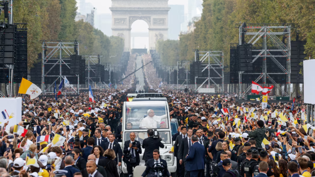 Pope Leo XIV in an open-top popemobile during Mass on the Champs-Élysées in Paris