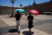Spain has recorded its hottest September on record, with temperatures reaching 45.7°C People are seeking shelter from the record-breaking heat under parasols in Spain