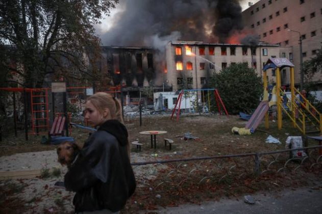 A building on fire near a children’s playground following an attack by the Russian Federation