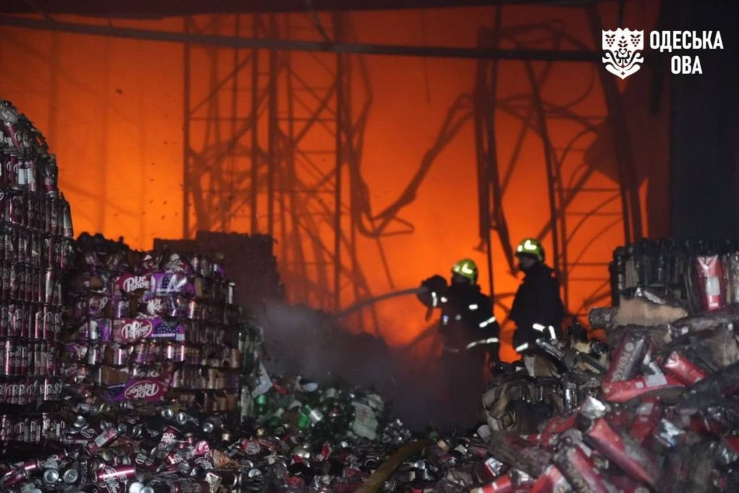 Rescue workers are putting out a fire at food warehouses following a Russian attack in the Odesa region