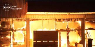 Flames have engulfed a building in the Odesa region; the fire is bursting through the damaged windows and doors.