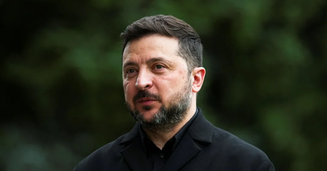 The President of Ukraine, Volodymyr Zelenskyy, in a black coat against a green backdrop