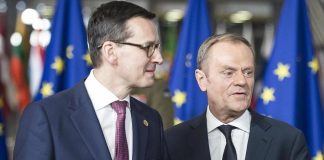 Mateusz Morawiecki and Donald Tusk against a backdrop of European Union flags.