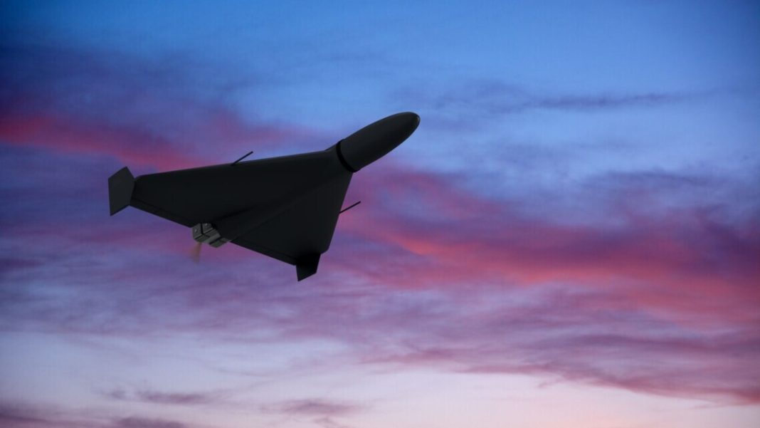 The silhouette of a drone in flight against the backdrop of the evening sky