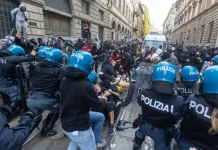 Riots have broken out in central Milan: fires and vandalism near the Duomo Italian police, wearing protective helmets and carrying shields, are facing off against a crowd of demonstrators on a street in Milan.