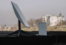 A Starlink satellite terminal and communications equipment on the roof of the building