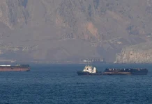 ALT: Ships are passing through the Strait of Hormuz off the coasts of Iran and Oman