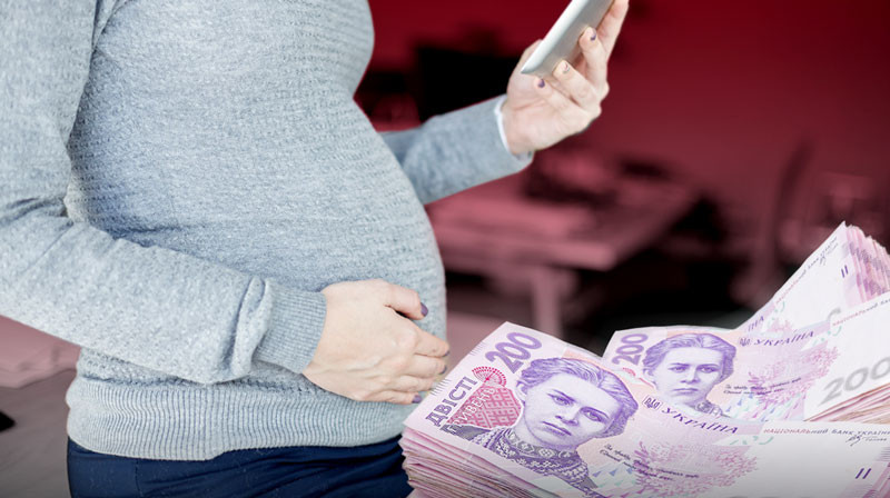 93a643fe1e90df9dae9e97f853c30d9c7f75a49b A pregnant woman holding a smartphone, with Ukrainian 200-hryvnia notes in the background — applying for state benefit via «Diyu».