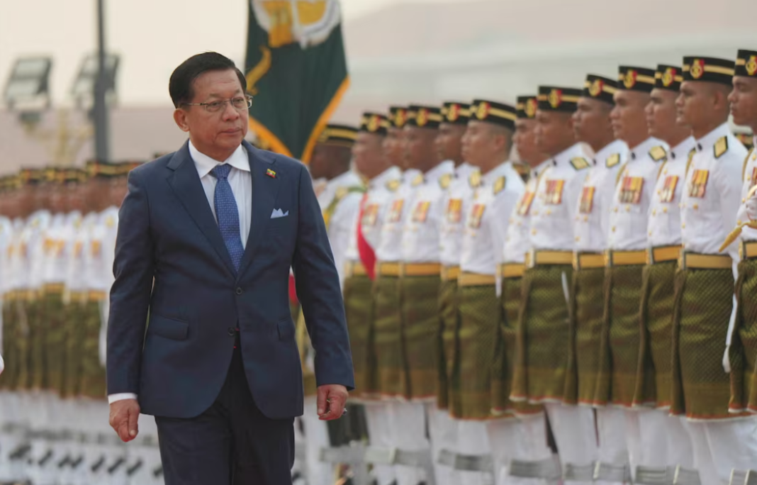 Min Aung Hline Min Aung Hlaing walks past a line of Myanmar military personnel