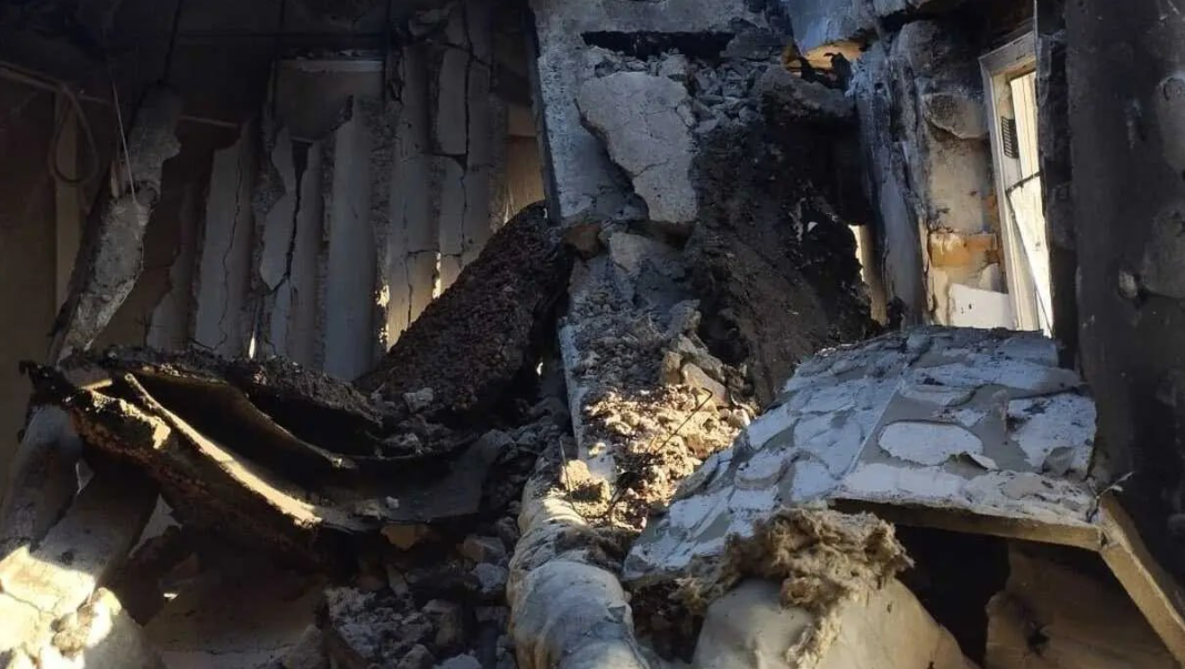 A ruined building with charred walls