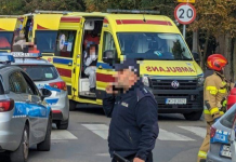 Police cars, ambulances and a rescue worker at the scene of an emergency in Poland