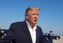 US President Donald Trump speaks to journalists at the airport