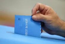 Виборець опускає блакитний конверт із бюлетенем у виборчу скриньку в Ізраїлі