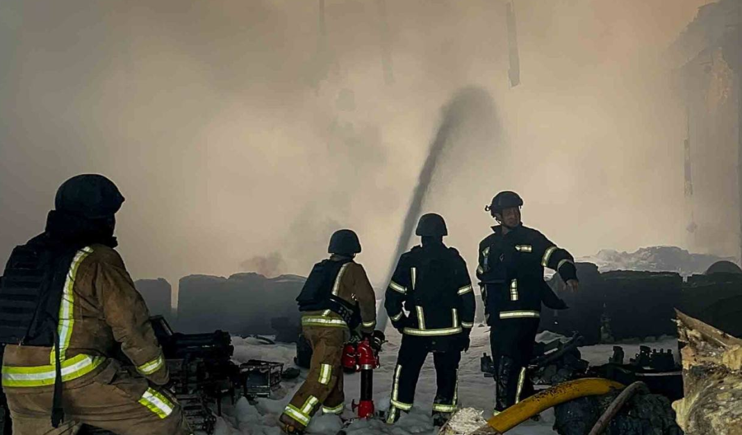 Rescue workers in Sumy Rescue workers in protective gear are putting out a fire amongst the rubble in a smoke-filled room