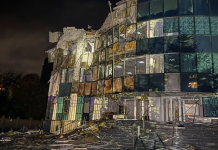 A damaged multi-storey building with shattered windows and a ruined façade following Russia’s night-time attack on the Kremenchuk district.