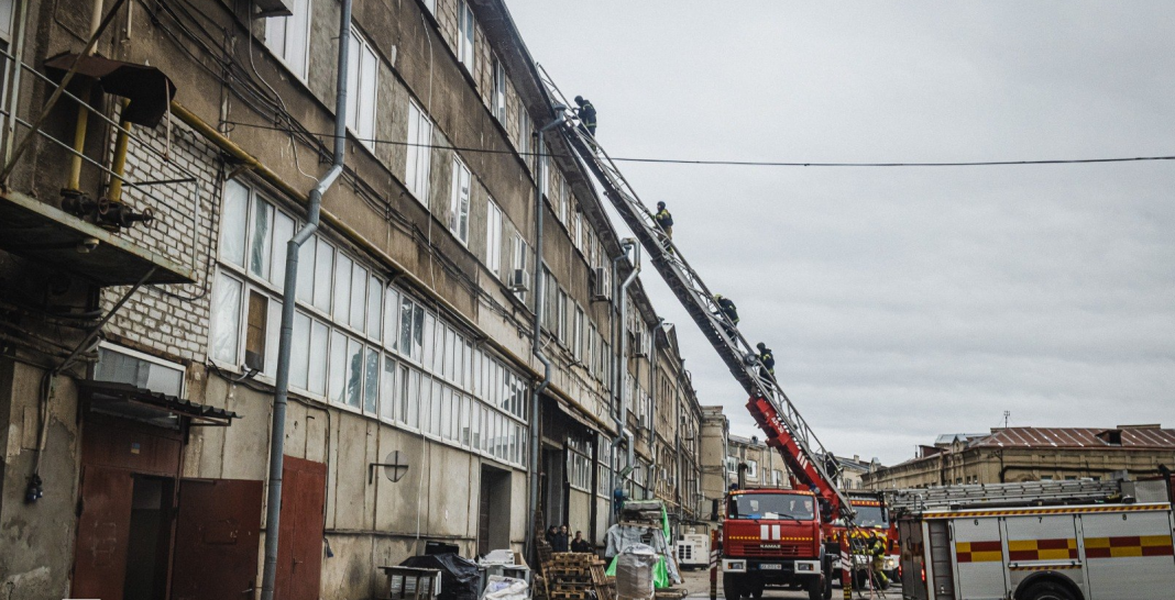 Rescue workers from the State Emergency Service on a fire ladder near a high-rise building in Kharkiv.
