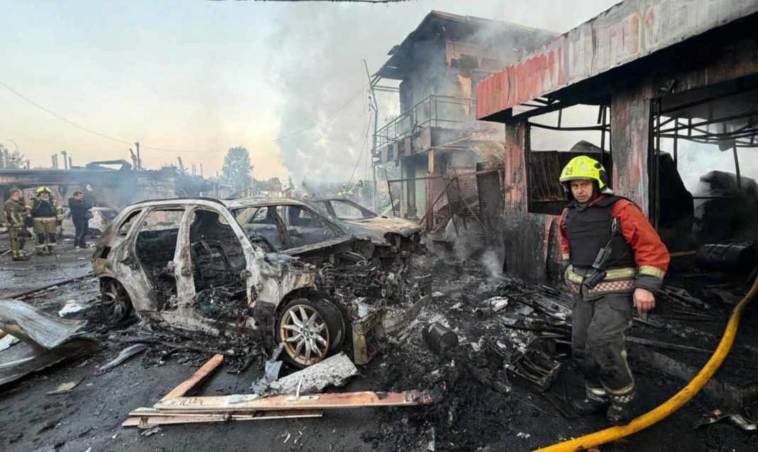 An attack on Kyiv A rescuer amongst burnt-out cars following the attack on Kyiv