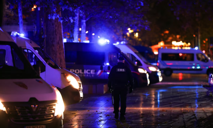 French police officers and specialist vehicles on a Paris street during heightened security measures.