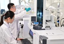 Китай став світовим центром випробувань ліків: які ризики Двоє науковців у білих лабораторних халатах і захисних окулярах працюють із сучасним аналітичним обладнанням у фармацевтичній лабораторії