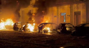Burning cars near a damaged building following the Russian attack on Kharkiv on 12 October 2026