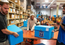 Election commission staff in Israel are sorting through blue boxes containing election materials