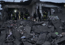 Rescue workers from the State Emergency Service are clearing the rubble of a residential building in Zaporizhzhia that was destroyed by a Russian air strike on 10 October 2026.
