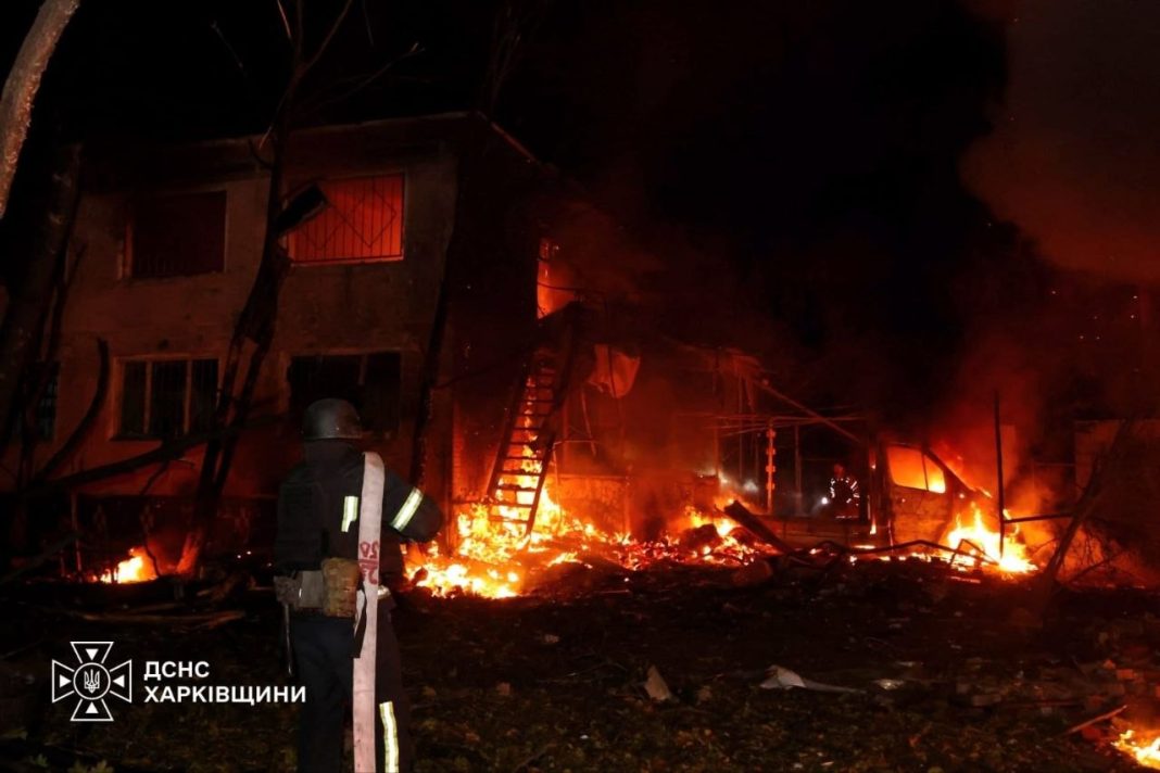 A State Emergency Service rescuer at the scene of a fire and a damaged building following the Russian shelling of Kharkiv