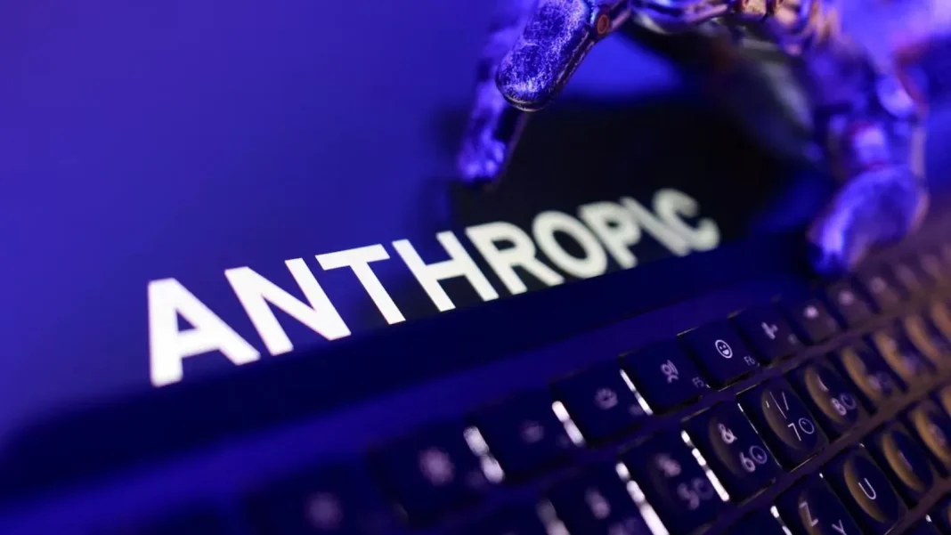 The Anthropic logo on a computer screen next to a keyboard, bathed in purple-blue light.