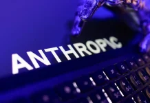 Anthropic has disclosed its financial results ahead of its IPO The Anthropic logo on a computer screen next to a keyboard, bathed in purple-blue light.