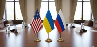 «We are moving towards the end of the war»: Ushakov announced a possible summit Table flags of the USA, Ukraine and Russia on the negotiating table in the diplomatic hall.