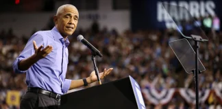 Obama accused the White House of making concessions to Putin Former US President Barack Obama is speaking to a large audience at the microphone during a political event.