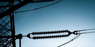 The silhouette of a pylon on a high-voltage power line
