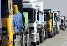 Черга вантажних автомобілів на автомобільній дорозі поблизу кордону. Фури очікують на проходження митного контролю.
