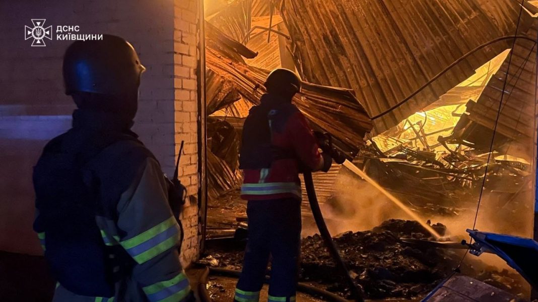 photo_2026-10-03_07-29-17 Rescue workers are putting out a fire in a warehouse in the Kyiv region following a Russian attack