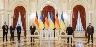 Ukraine and Germany have signed a declaration on countering unmanned aerial vehicles Officials are standing by the tables where the documents are to be signed, against a backdrop of the Ukrainian and German flags
