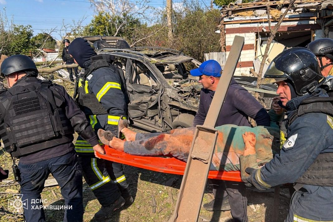 photo_2026-10-05_16:13:55 Rescue workers are evacuating a casualty following the Russian strike on Chuhuiv