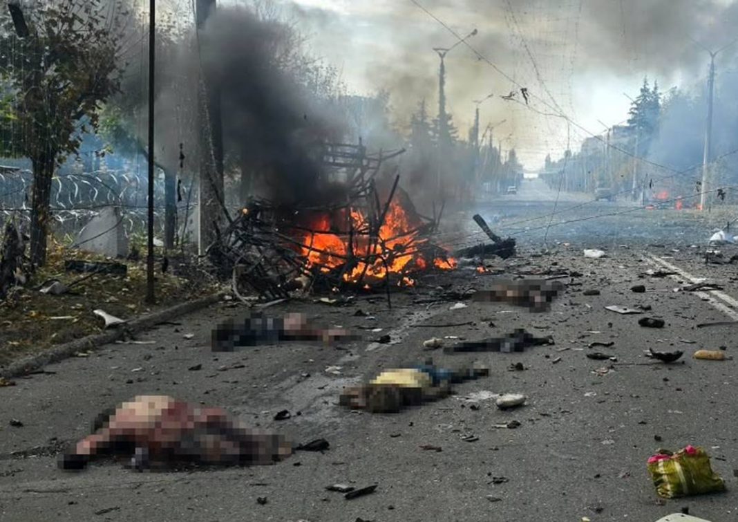 The aftermath of the Russian strike on a minibus in Kramatorsk on 8 October 2026 — burning wreckage and a section of road destroyed.