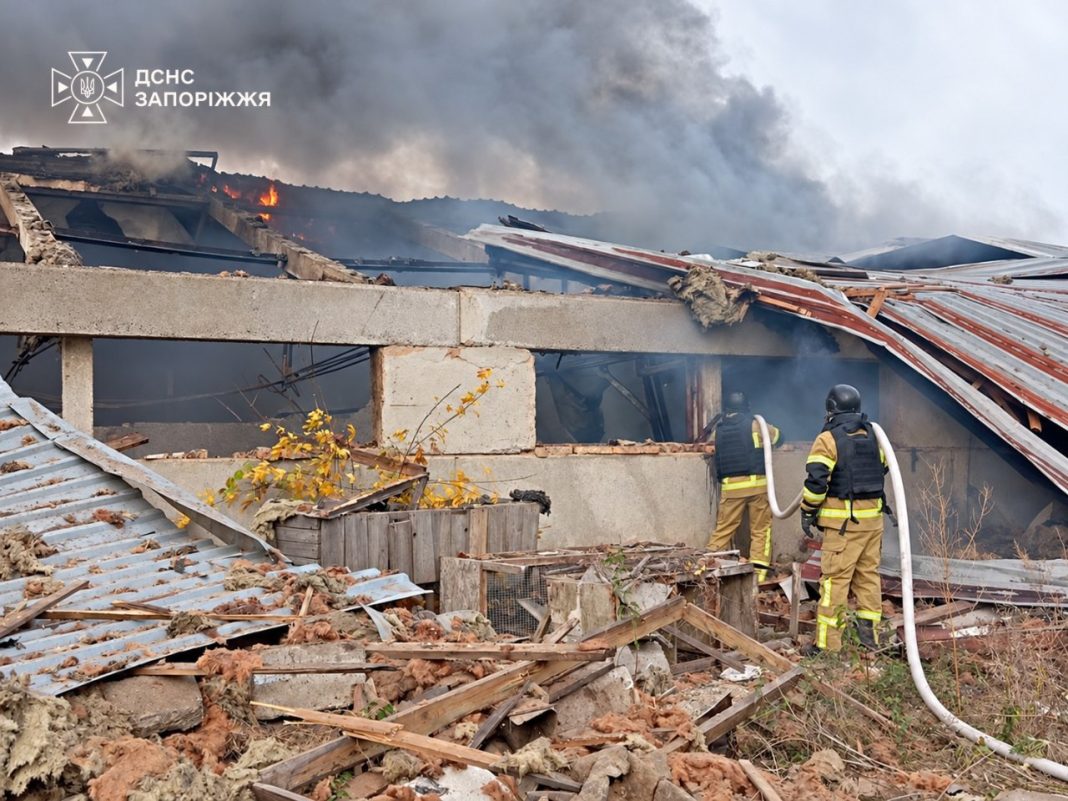 photo_2026-10-13_13-09-34 Rescue workers from the State Emergency Service are putting out a fire in a damaged warehouse following a Russian strike on Zaporizhzhia on 13 October 2026