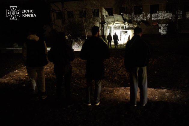 People near a damaged building in Kyiv following a Russian ballistic missile attack during the night on 27 October 2026