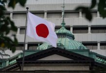 The Japanese flag is flying outside a building in Tokyo