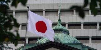 Japan has imposed new sanctions against Russia and restrictions on 35 vessels The Japanese flag is flying outside a building in Tokyo